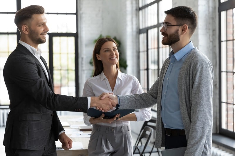 confident-business-people-handshaking-greeting-and-acquaintance-picture-id1247026218-min