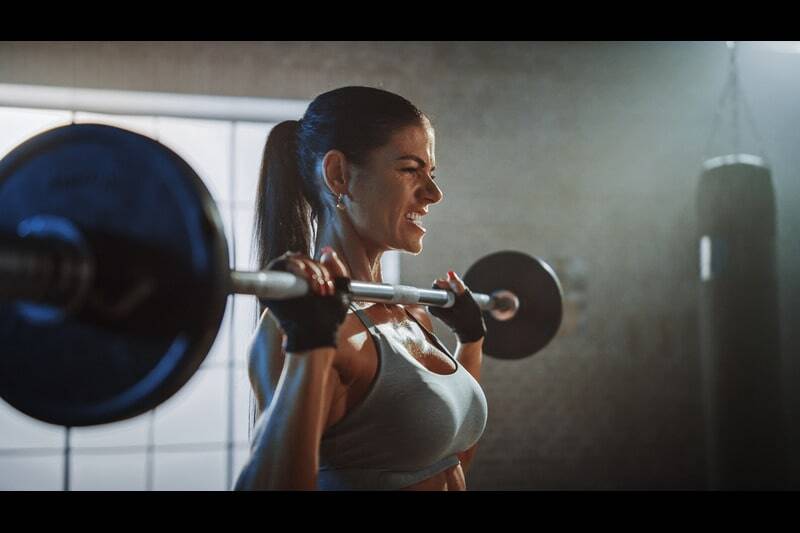 Female TA leader lifting weights for physical and mental fitness